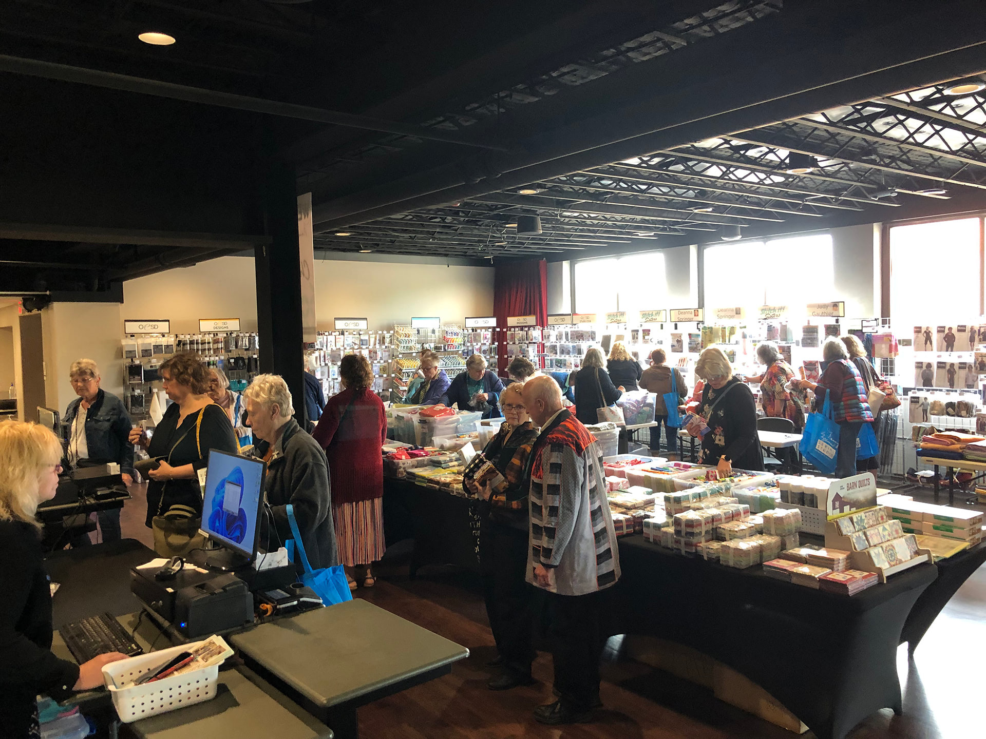 People shopping sewing supplies in Encore Hall