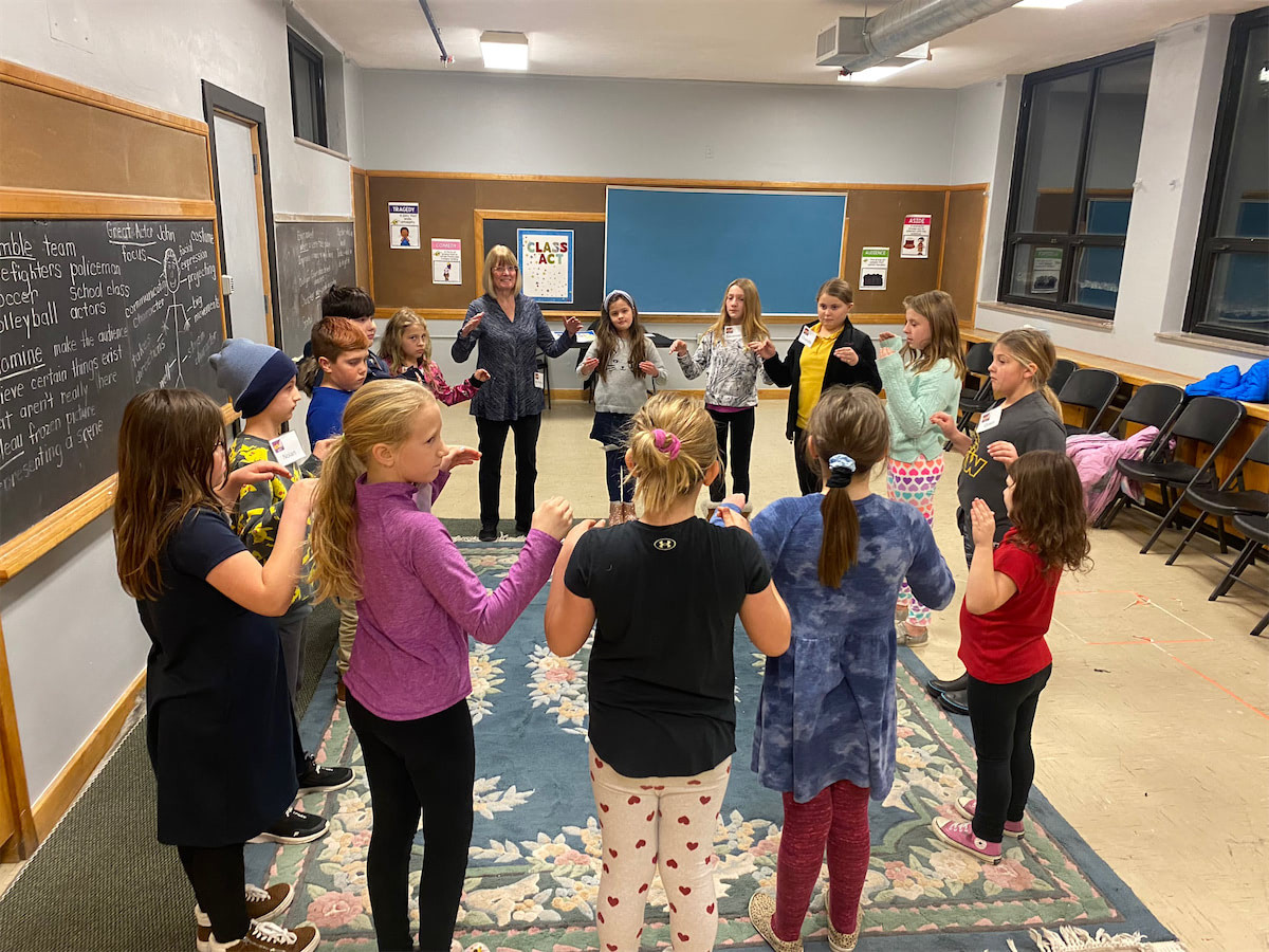 Classroom of kids standing in a circle