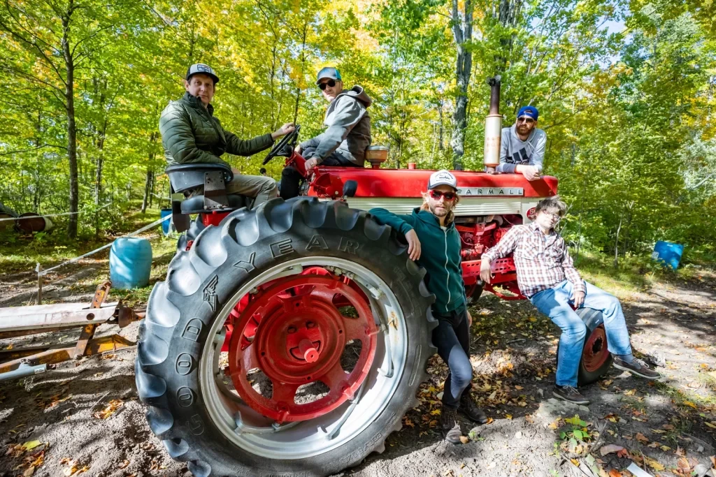 The MilBillies band members on a tractor.
